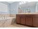 Spa-like bathroom with soaking tub and double sinks at 6829 Sundrop St, Harmony, FL 34773