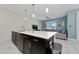 Modern kitchen with white quartz countertops and dark cabinetry at 8930 Stinger Dr, Davenport, FL 33896