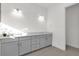 Bathroom with gray vanity, double sinks, and tile floors at 2692 Meadowedge Loop, St Cloud, FL 34772