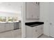Modern kitchen with gray cabinets, granite countertops, and stainless steel appliances at 2692 Meadowedge Loop, St Cloud, FL 34772