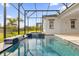 Inviting pool and spa with a tranquil waterfall feature at 2692 Meadowedge Loop, St Cloud, FL 34772
