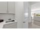 Laundry room with sink and white cabinets at 2692 Meadowedge Loop, St Cloud, FL 34772