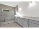 Spa-like bathroom with large shower, gray tile, and double vanity at 2692 Meadowedge Loop, St Cloud, FL 34772