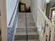 Gray tile stairs with a white railing at 438 Spike Ct, Kissimmee, FL 34759