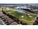 Aerial view of a golf course next to residential homes at 8932 Stinger Dr, Davenport, FL 33896