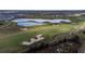 Aerial view of a golf course with lakes and fairways at 8932 Stinger Dr, Davenport, FL 33896