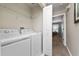Laundry room with washer, dryer, and shelving at 8932 Stinger Dr, Davenport, FL 33896