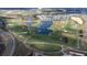 Aerial view of a golf course with houses and lakes at 8932 Stinger Dr, Davenport, FL 33896