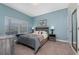 Cozy bedroom with a queen-size bed and a full-length mirror at 8932 Stinger Dr, Davenport, FL 33896