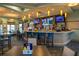 Community clubhouse bar with seating and multiple TV screens at 8932 Stinger Dr, Davenport, FL 33896