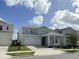 Two-story house with light gray siding and three-car garage at 13193 Tollcross Way, Winter Garden, FL 34787