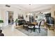 Elegant dining room with dark wood table and chairs, adjacent to the living area at 1703 Encinitas Way, Kissimmee, FL 34759