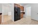 Kitchen boasts wood cabinets, granite counters, and black appliances at 3838 Gulf Shore Cir, Kissimmee, FL 34746
