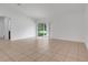 Living room with tile floor and sliding glass doors at 3838 Gulf Shore Cir, Kissimmee, FL 34746