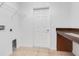 Laundry room with built-in shelving and granite countertop at 3838 Gulf Shore Cir, Kissimmee, FL 34746