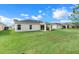 View of home from backyard showing grassy area at 3838 Gulf Shore Cir, Kissimmee, FL 34746