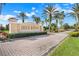 The Isles of Calago entrance, featuring a brick road and lush landscaping at 3838 Gulf Shore Cir, Kissimmee, FL 34746