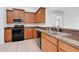 Modern kitchen with wood cabinets and granite countertops at 3838 Gulf Shore Cir, Kissimmee, FL 34746