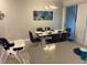 Modern dining room with a large table and gray chairs at 4295 Paragraph Dr, Kissimmee, FL 34746