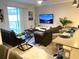Spacious living room with TV and pool view at 4295 Paragraph Dr, Kissimmee, FL 34746