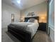 Main bedroom with a king-size bed, nightstands, and large window at 4295 Paragraph Dr, Kissimmee, FL 34746