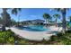 Community pool with plenty of lounge chairs and a large sundeck at 4295 Paragraph Dr, Kissimmee, FL 34746