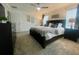 King-size bedroom with a ceiling fan, large windows and dark dresser at 4295 Paragraph Dr, Kissimmee, FL 34746