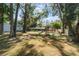 Large backyard with playset and shed, surrounded by lush greenery at 4321 Rummell Rd, St Cloud, FL 34769