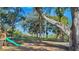 Spacious backyard with mature trees, playground, and water view at 4321 Rummell Rd, St Cloud, FL 34769