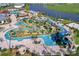 Aerial view of resort-style pool, lazy river, and waterslide at 4751 Clock Tower Dr # 107, Kissimmee, FL 34746