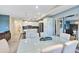 Modern dining area with a large table, white chairs, and an open view to the kitchen at 4751 Clock Tower Dr # 107, Kissimmee, FL 34746