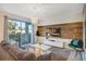 Living room with wood-look wall, comfy couch and sliding door access to a balcony at 4751 Clock Tower Dr # 107, Kissimmee, FL 34746