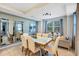 Bright dining room with a large table, six chairs, and two full-length mirrors at 4751 Clock Tower Dr # 107, Kissimmee, FL 34746