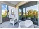 Private patio with chairs and sliding glass doors at 4751 Clock Tower Dr # 107, Kissimmee, FL 34746