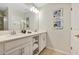 Elegant bathroom with a double vanity, white cabinets, and stylish artwork at 4751 Clock Tower Dr # 107, Kissimmee, FL 34746