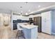 Modern kitchen with white cabinets, stainless steel appliances, and a large island at 4751 Clock Tower Dr # 107, Kissimmee, FL 34746