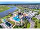 Aerial view of community amenities, including pools and lake at 4751 Clock Tower Dr # 107, Kissimmee, FL 34746