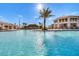 Large resort-style pool with palm trees and a pool bar at 4751 Clock Tower Dr # 107, Kissimmee, FL 34746