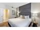 Main bedroom with a king-size bed, gray accent wall, and plenty of natural light at 4751 Clock Tower Dr # 107, Kissimmee, FL 34746