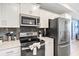 Modern kitchen with stainless steel appliances and white cabinetry at 4751 Clock Tower Dr # 107, Kissimmee, FL 34746
