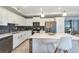 Modern kitchen features white cabinets, stainless steel appliances & large island at 4751 Clock Tower Dr # 107, Kissimmee, FL 34746