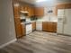 Bright kitchen with wood cabinets, new flooring, and modern appliances at 523 Royal Ridge Dr, Davenport, FL 33837