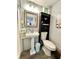 Clean bathroom with pedestal sink, toilet, and storage at 5312 Goddard Ave, Orlando, FL 32810