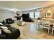 Open living and dining area with dark leather sofas and a fireplace at 5312 Goddard Ave, Orlando, FL 32810