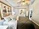 Spacious bedroom with a queen bed, dresser, and large wall art at 5312 Goddard Ave, Orlando, FL 32810