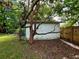 White shed with green trim nestled in a backyard setting at 5312 Goddard Ave, Orlando, FL 32810