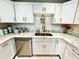 Bright kitchen with white cabinets, marble countertops, and stainless steel appliances at 5312 Goddard Ave, Orlando, FL 32810