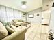 Cozy living room with light beige sofas and a white coffee table at 5312 Goddard Ave, Orlando, FL 32810