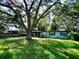 Home with mature landscaping and a large tree in the front yard at 5312 Goddard Ave, Orlando, FL 32810