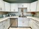 Bright kitchen with white cabinets, marble countertops, and stainless steel appliances at 5312 Goddard Ave, Orlando, FL 32810